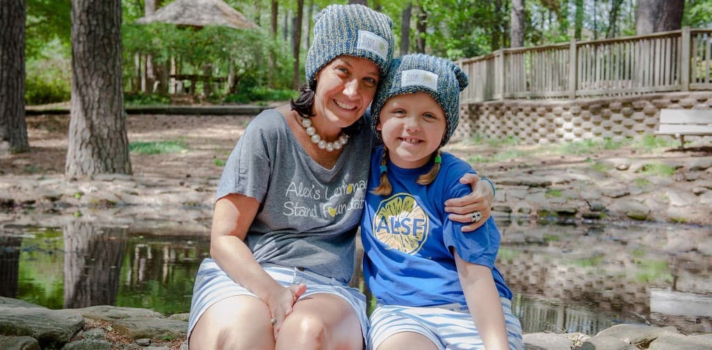 Supporters in Alex's Lemonade Stand Foundation shirts by the water