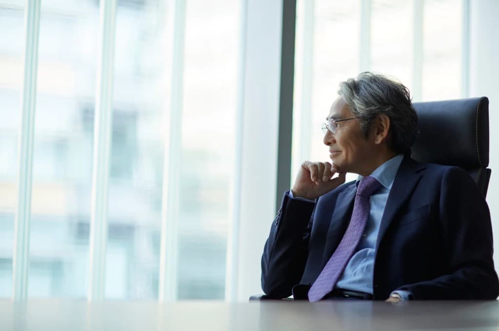 Healthcare IT leader in thoughtful reflection by an office window.